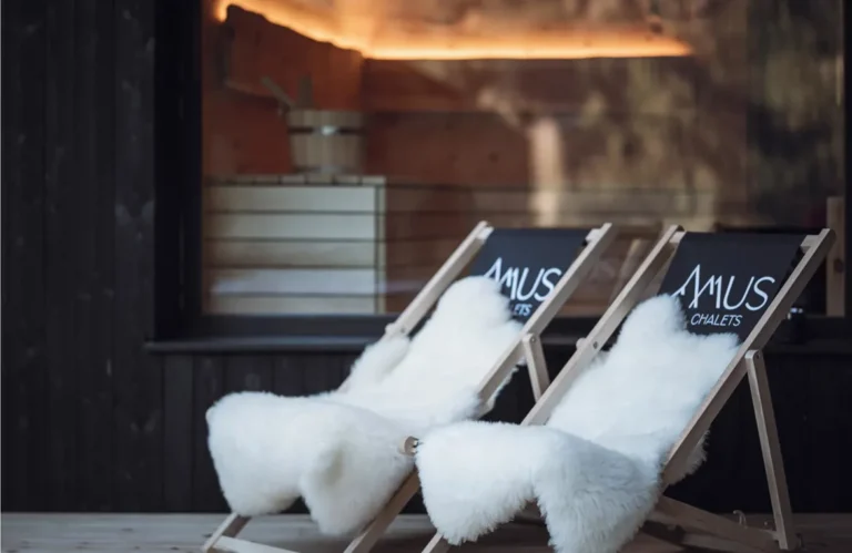 Printed deckchairs with sheepskins outside a chalet