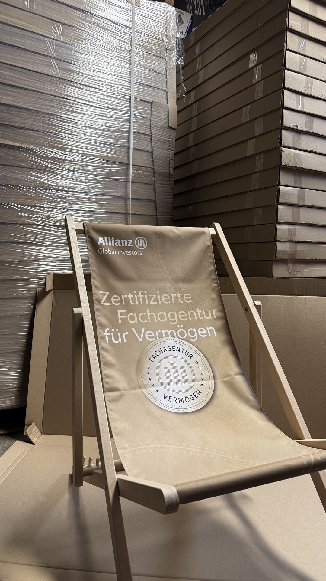 Printed deckchair set up in front of stacked boxes