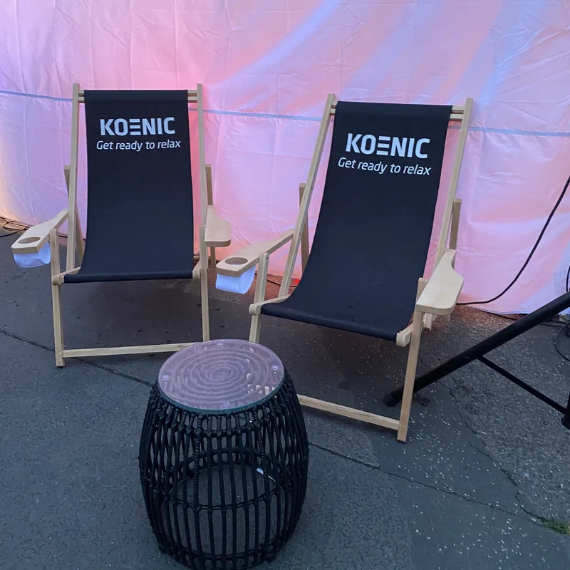 Two printed deckchairs with company logo at an event