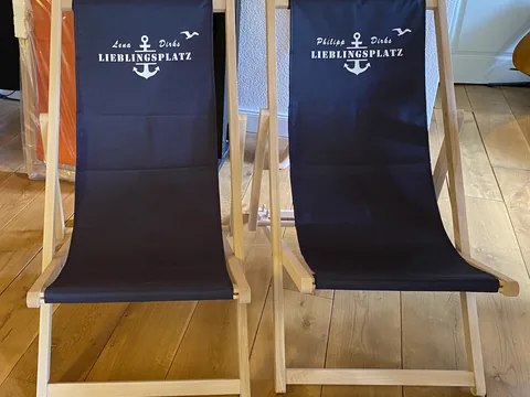 Dark blue personalised deckchairs for a wedding couple